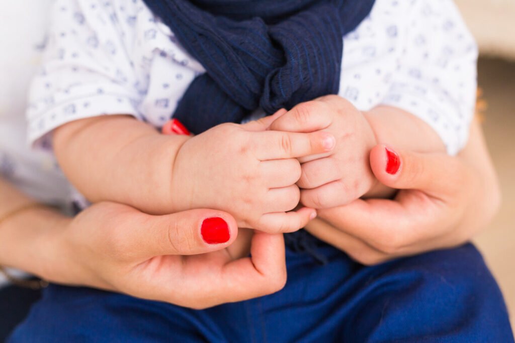 family-baby-hands-mother-holding-newborn-kid-child-hand-closeup-into-parents